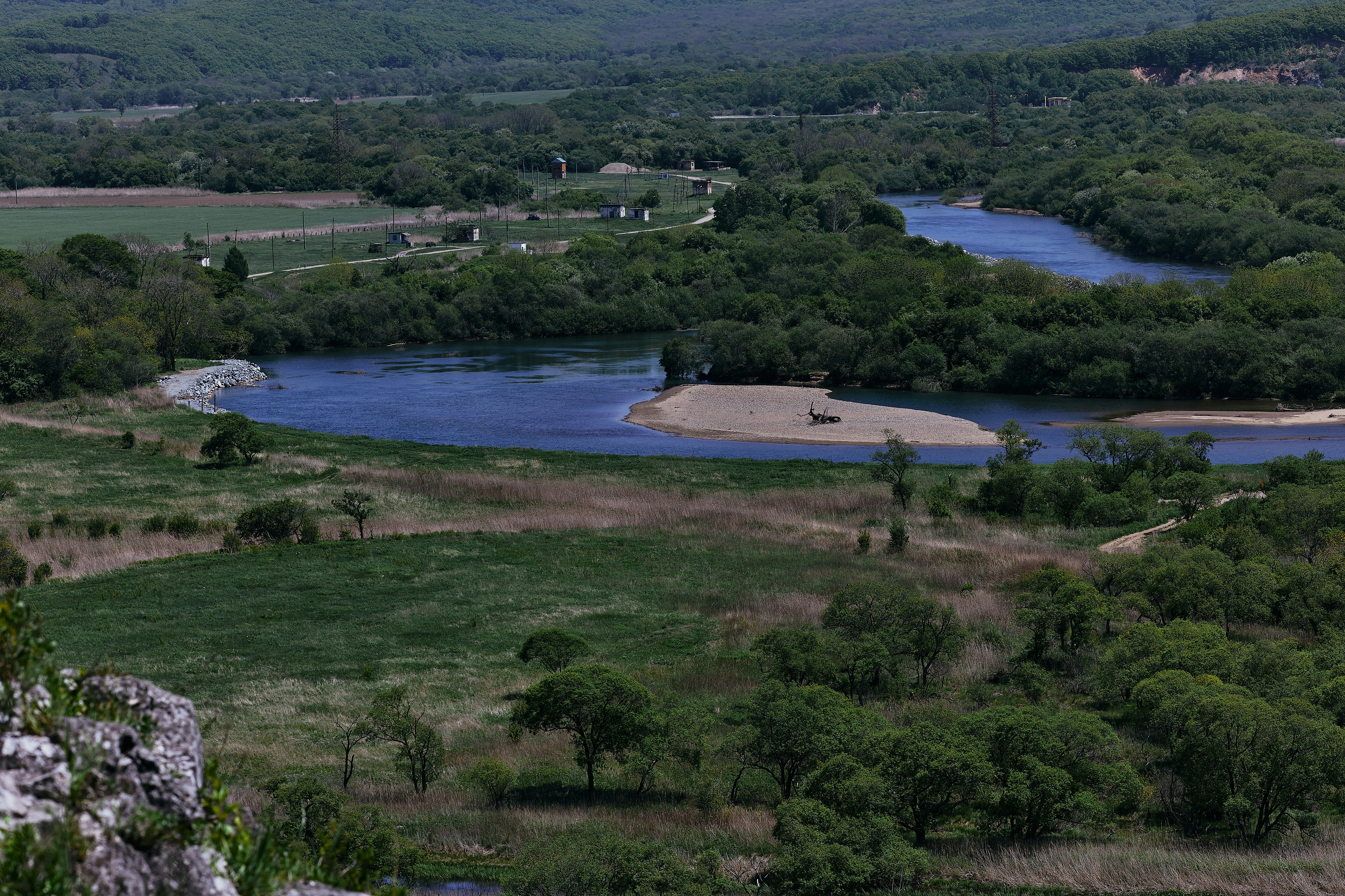 green grass field near body of water during daytime